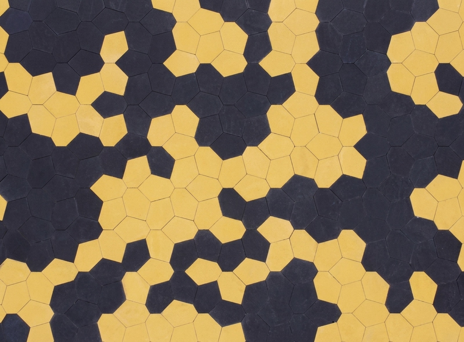 PENTA layout pattern showing yellow five-sided pavers set into a black field