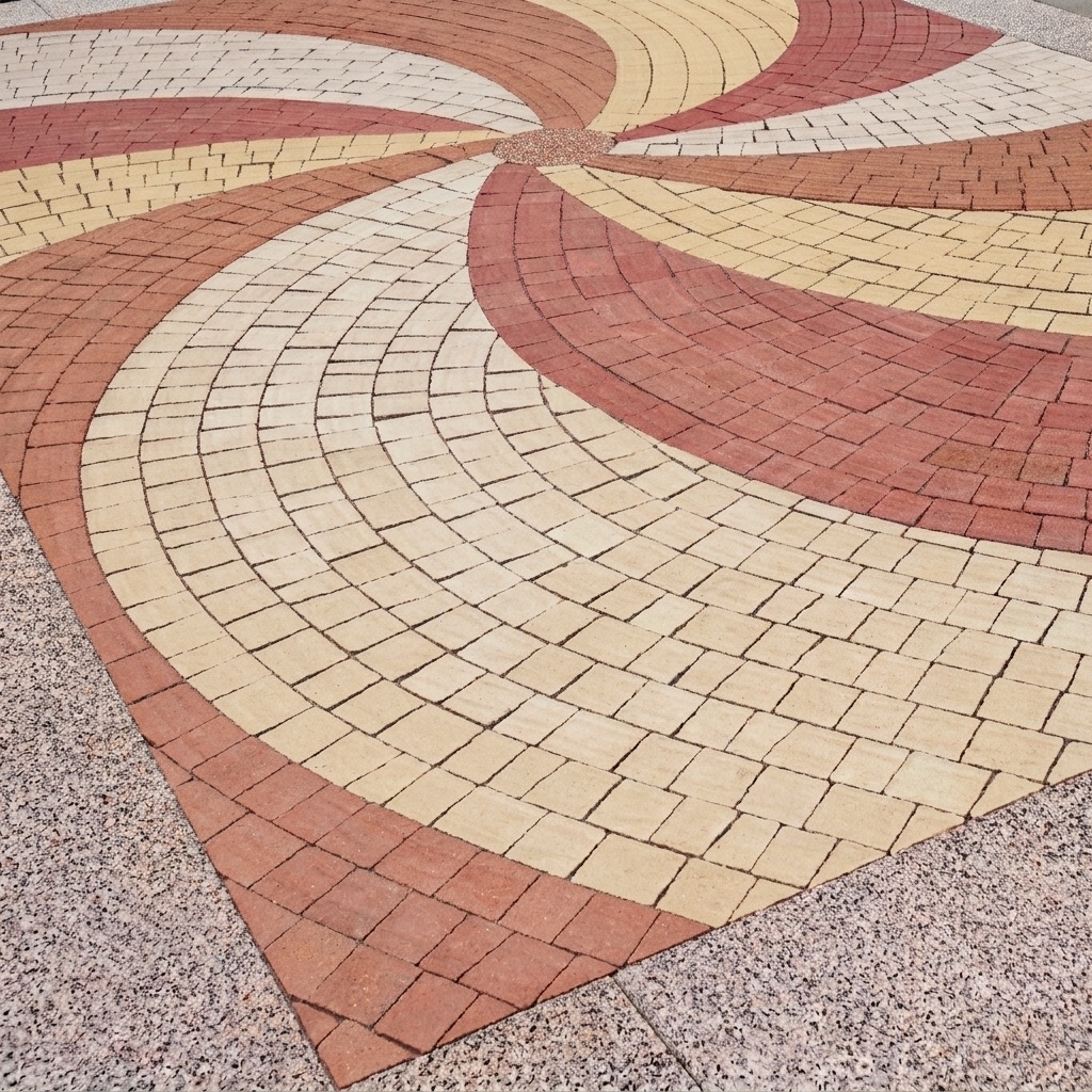 VILLAGIO cobble paving laid as a large swirl in red, beige and cream